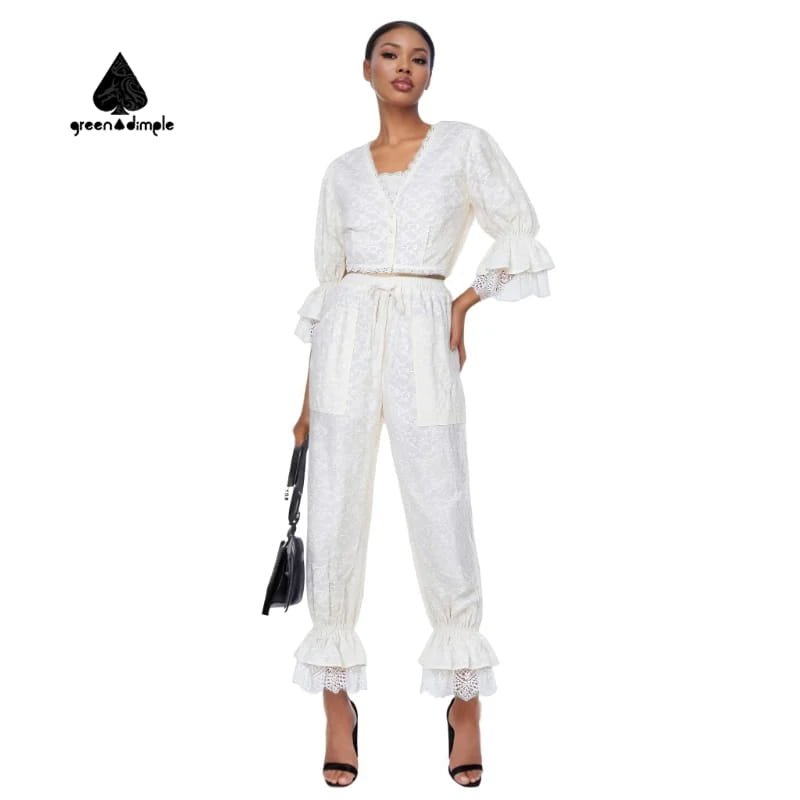 White lace two piece set for women with ruffle sleeves and relaxed fit pants front view