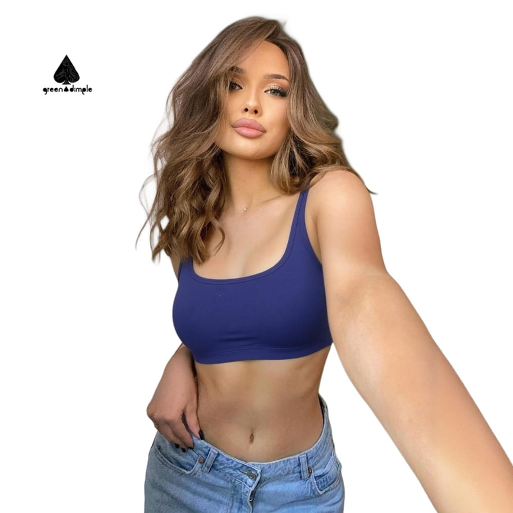 Front view of woman wearing Greendimple blue crop top with light blue jeans